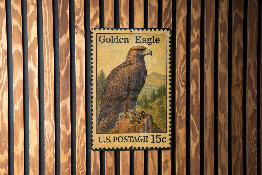 A U.S. postage stamp featuring a golden eagle perched on a rock, mounted on a wooden wall.