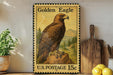 A vintage-style postage stamp featuring a golden eagle, with a price of 15 cents, is displayed on a shelf next to a wooden cutting board and some lemons.