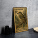 A U.S. postage stamp featuring a golden-crowned kinglet perched on a branch, with a textured background and a small bird illustration.