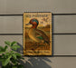 A U.S. postage stamp featuring a green-winged teal duck, mounted on a wall next to a plant.