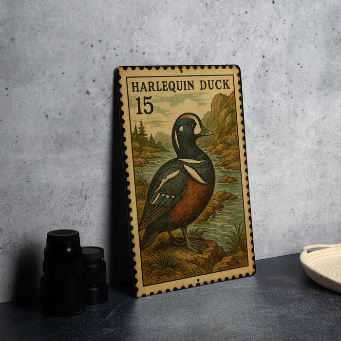 A metal stamp featuring a harlequin duck, with the text "HARLEQUIN DUCK 15" printed on it.