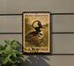 A vintage postage stamp featuring a hooded merganser duck, mounted on a wall next to a plant.