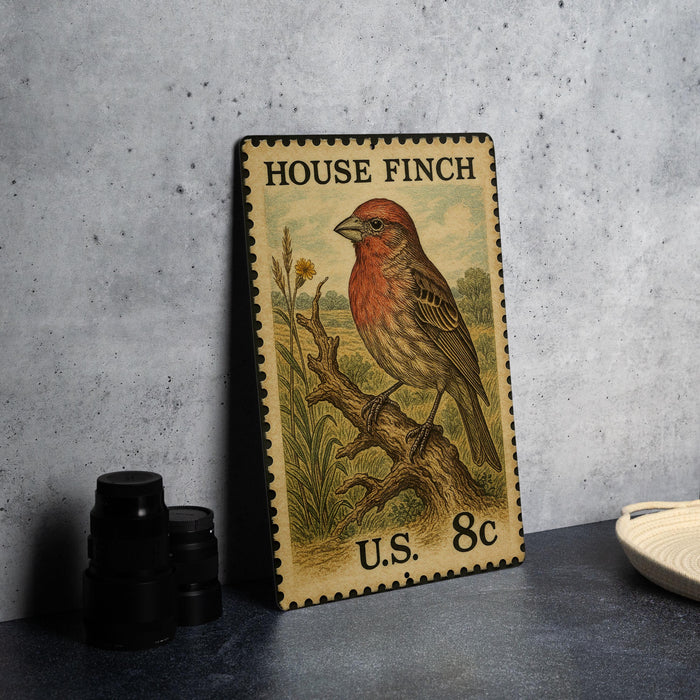 A vintage-style postage stamp featuring a red-headed bird perched on a branch, with the text "HOUSE FINCH" and "U.S. 8c" printed on it.