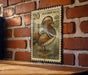 A vintage postage stamp featuring a colorful illustration of a mandarin duck is displayed on a brick wall.