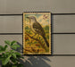 A postage stamp featuring a bird, likely a Northern Mockingbird, is displayed on a wall.