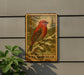A wooden sign with a red bird perched on a pine tree, mounted on a gray wall.
