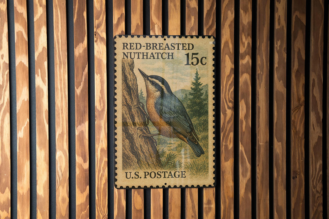 A U.S. postage stamp featuring a nuthatch perched on a tree, with the text "RED-BREasted NUTHATCH 15c" and "U.S. POSTAGE" printed on it.