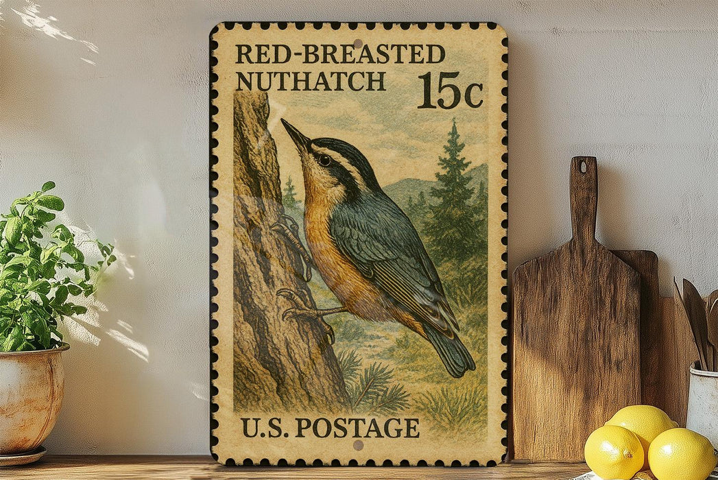 A framed U.S. postage stamp depicting a red-breasted nuthatch, placed on a wooden surface next to a wooden cutting board and a potted plant.