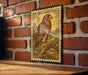 A framed illustration of a red-shoed hawk is displayed on a brick wall, with a wooden table below it.