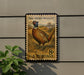 A vintage U.S. postage stamp featuring a pheasant standing in a grassy field.