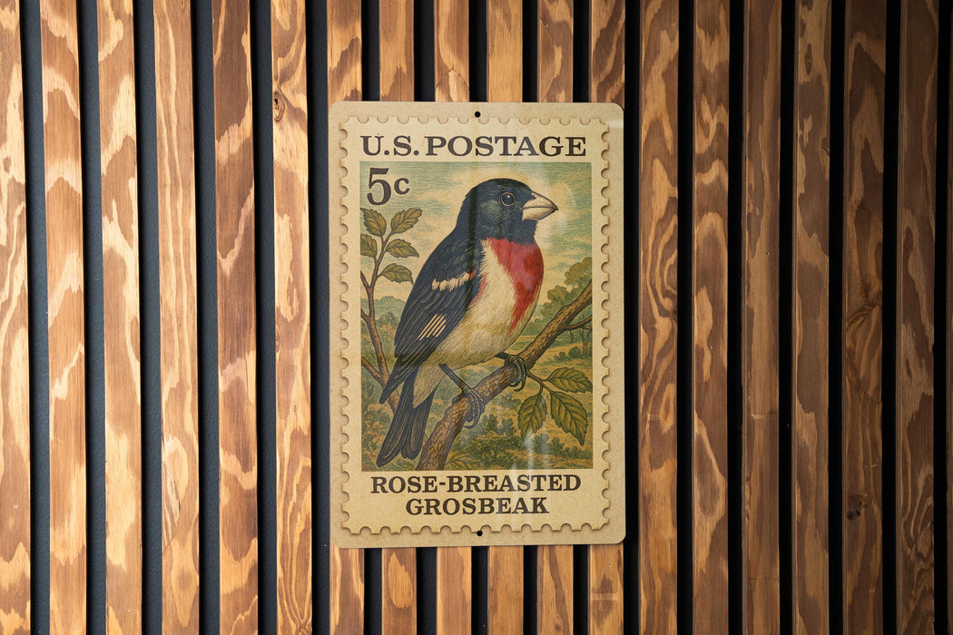 A U.S. postage stamp featuring a rose-breasted grosbeak perched on a branch.