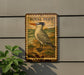 a wooden sign with a bird illustration, mounted on a wall.