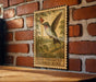 A wooden frame with a vintage-style illustration of a hummingbird, mounted on a brick wall.