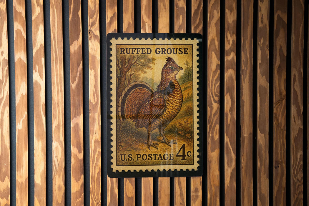 A U.S. postage stamp featuring a detailed illustration of a grouse bird, mounted on a wooden wall.