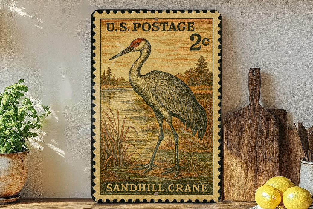 A vintage U.S. postage stamp featuring a sandhill crane is displayed on a shelf next to a wooden cutting board and a potted plant.