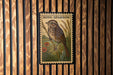 A postage stamp featuring a detailed illustration of a bird, specifically a sparrow, perched on a branch with flowers.