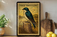 A framed illustration of a blue and white bird perched on a tree stump, with a vintage-style border, is displayed on a shelf next to a wooden cutting board and a potted plant.
