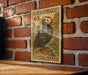 A U.S. postage stamp featuring a puffin bird is displayed on a brick wall.