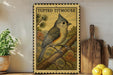 a framed illustration of a Tufted Titmouse perched on a branch, with a potted plant and kitchen utensils visible in the background.
