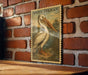 A vintage-style stamp depicting a pelican is hanging on a brick wall.