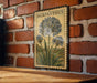 a vintage-style botanical illustration of a flower, specifically a lily, mounted on a brick wall.