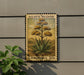 A U.S. postage stamp featuring an illustration of an agave plant, mounted on a wall next to a plant.