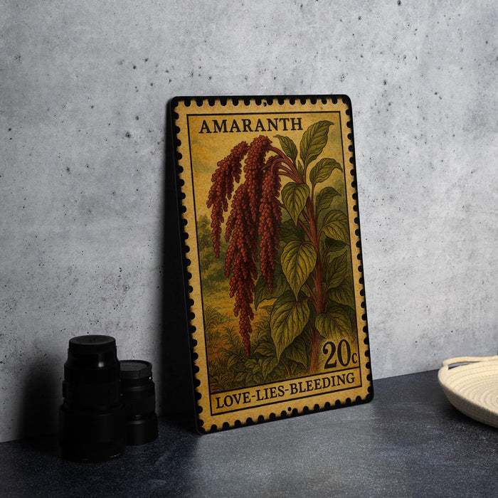 A metal stamp with a floral design and text, placed on a countertop next to some black camera lenses.