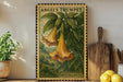 A framed illustration of a trumpet flower is displayed on a shelf, accompanied by a wooden cutting board, a potted plant, and a lemon.