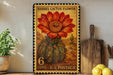 A framed image of a barrel cactus flower, with a vintage-style stamp on the back.