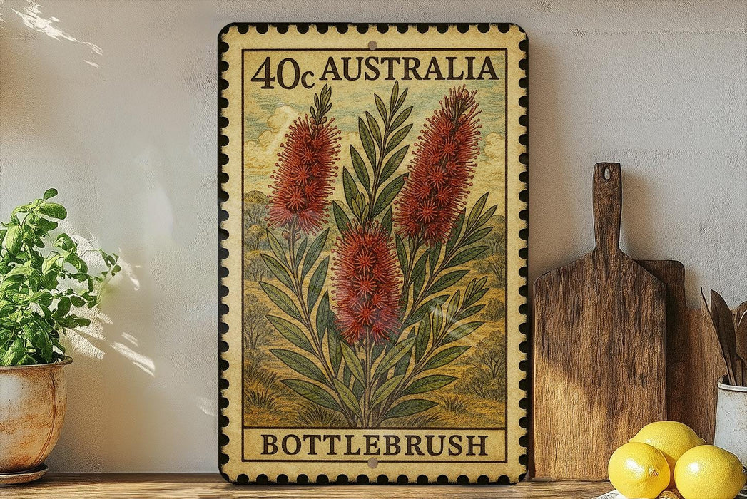 a framed vintage stamp with a floral design, placed on a shelf next to a wooden cutting board and some lemons.