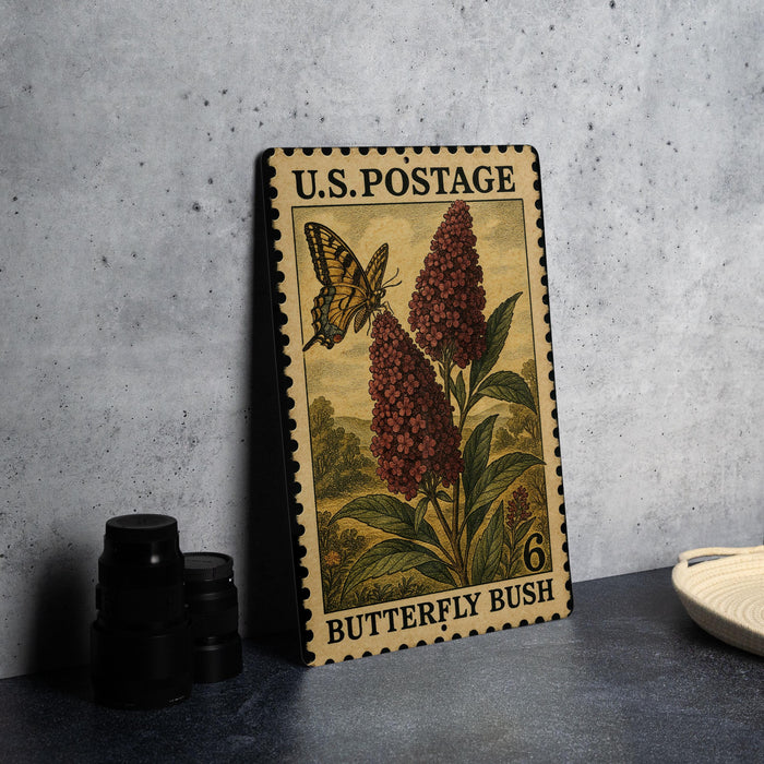 A U.S. postage stamp featuring a butterfly and a flowering bush, with the text "Butterfly Bush" printed on it.
