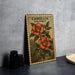 A framed illustration of a red flower with green leaves, labeled "CAMELIA SASANQUA", is displayed on a gray wall.