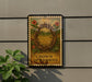 a sign with a crown of thorns design, mounted on a wall next to a plant.