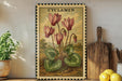 a framed illustration of pink cyclamen flowers on a wooden shelf, accompanied by a wooden cutting board and a potted plant.