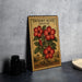 A decorative metal sign with a vintage-style illustration of a desert rose plant, featuring red flowers and green leaves, is displayed on a gray countertop.