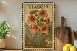 a vintage postage stamp with a floral design, placed on a shelf next to a wooden cutting board and some potted plants.