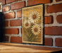 A vintage-style metal stamp with a floral design is displayed on a brick wall, featuring three large white daisies.