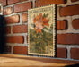 A vintage-style postage stamp featuring a detailed illustration of a flower on a brick wall.