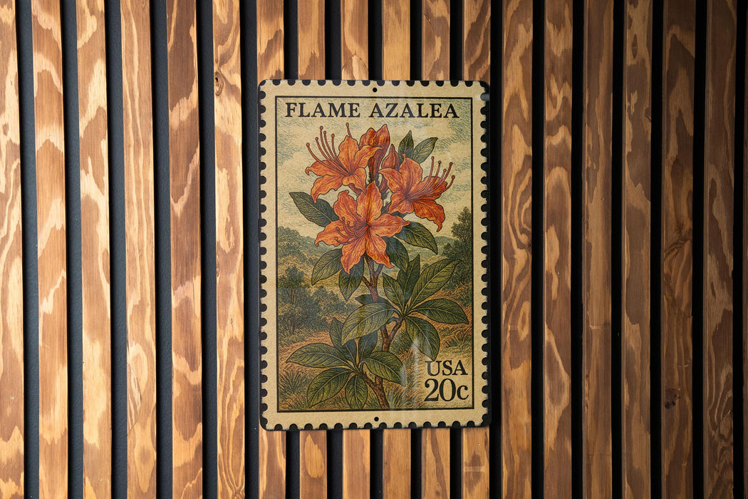 A postage stamp featuring a vibrant illustration of a flame azalea plant, with the text "FLAME AZALEA" and "USA 20c" printed on it.