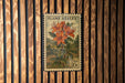 A postage stamp featuring a vibrant illustration of a flame azalea plant, with the text "FLAME AZALEA" and "USA 20c" printed on it.