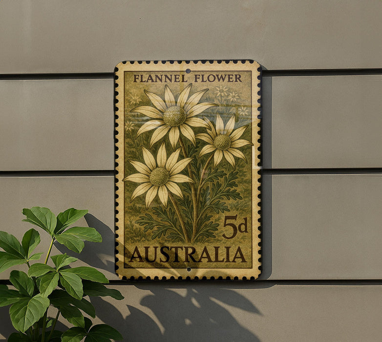 a postage stamp with a floral design, mounted on a wall next to a plant.
