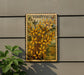 a postage stamp with a floral design, mounted on a wall next to a plant.