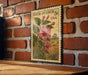 A vintage-style postage stamp featuring a pink flower and green leaves, mounted on a brick wall.