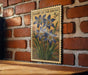 A vintage postage stamp featuring a floral design is displayed on a brick wall.