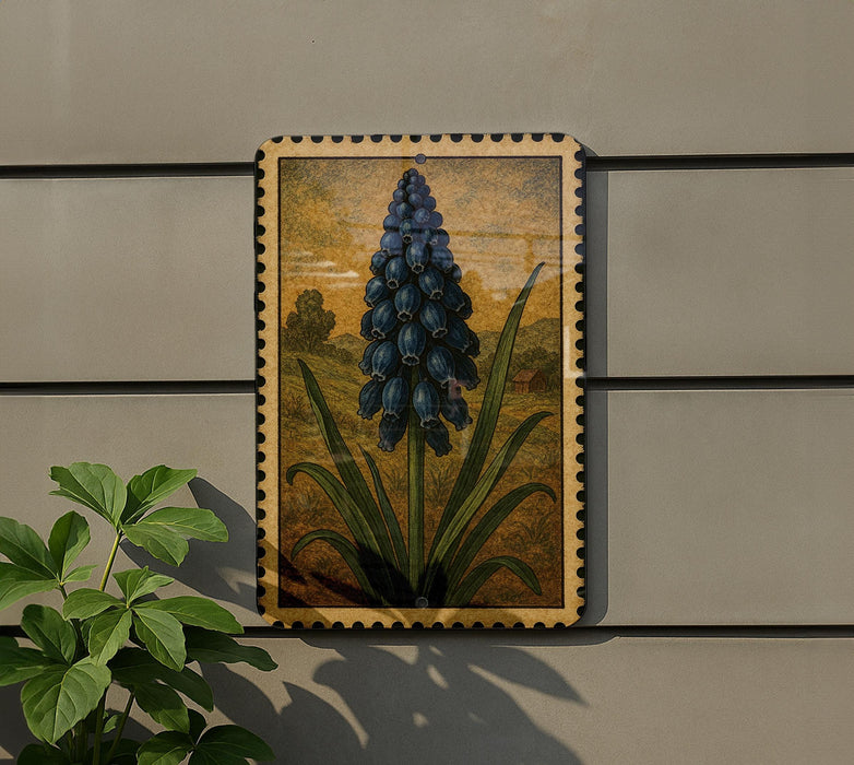 a framed painting of a blue flower on a wall, with a plant next to it.