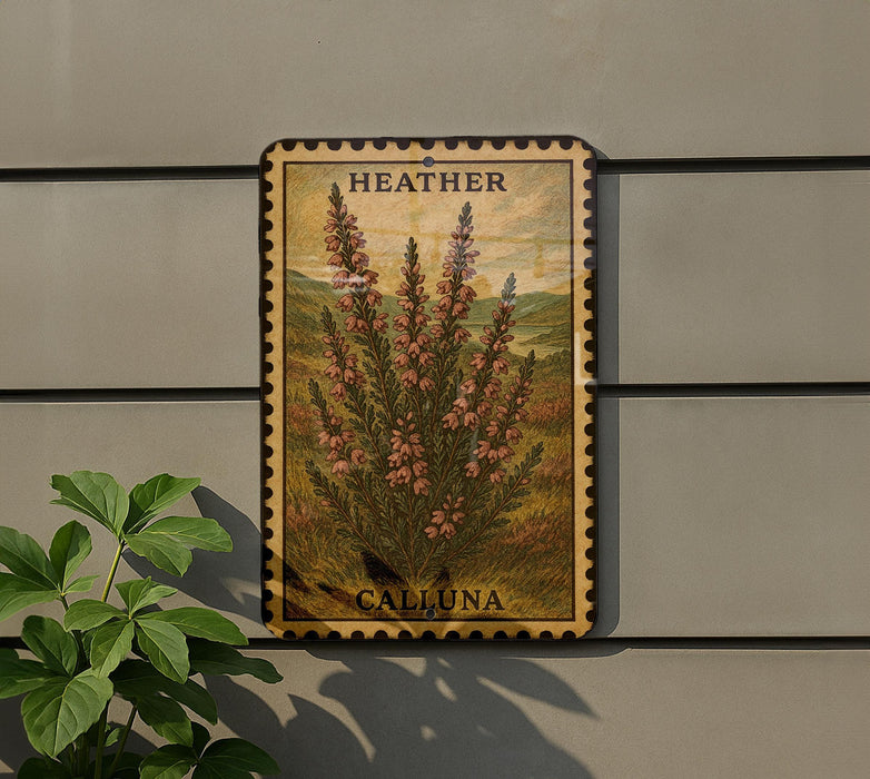 A metal sign with a floral illustration and the word "HEATHER" is mounted on a wall, next to a plant.