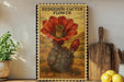 A framed illustration of a hedgehog cactus flower is displayed on a shelf, accompanied by a wooden cutting board and a potted plant.