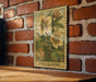 A framed illustration of a flower is hanging on a brick wall, with the word "HELLEREBORE" printed below it.