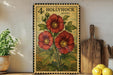 A vintage-style stamp depicting red hibiscus flowers is displayed on a shelf, accompanied by a wooden cutting board, a potted plant, and a bowl of lemons.