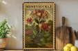 A framed illustration of a honeysuckle flower is displayed on a shelf, accompanied by a wooden cutting board, a potted plant, and a lemon.